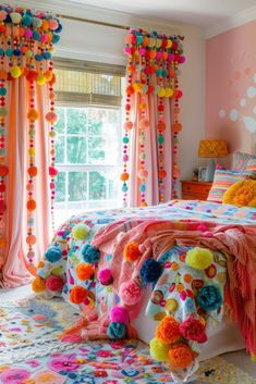 a bedroom decorated in bright colors with pom - poms on the bed and curtains