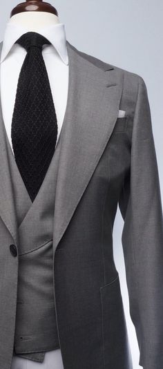 Made from a rare year-round tick-weave wool, this Milano cut three-piece suit features a perfect shade of grey and a matching double-breasted waistcoat, along with our signature one-button placement, double vents, patch pockets, natural shoulder, and wide peak lapels. The accompanying slim trousers are flat front with a wide waistband and feature our versatile side adjusters. Red Overcoat, Brown Chukka Boots, Grey Overcoat, Grey Suit Men, Navy Blue Tuxedos, Double Breasted Waistcoat, Mens Overcoat, Flannel Suit, Herren Style