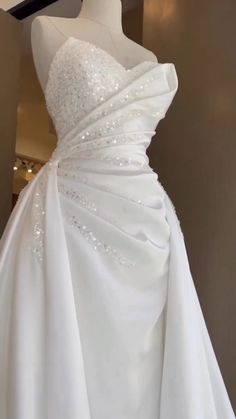 a white wedding dress on display in a store