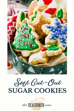 a bowl filled with christmas cookies on top of a table