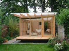 a small wooden structure in the middle of a yard