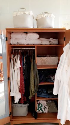 an open closet with clothes and other items