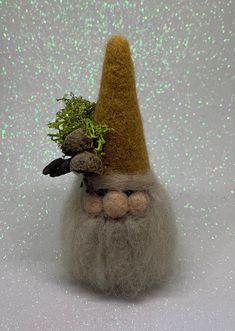 a needled gnome with a green hat on his head is shown against a white background