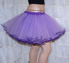 "The main fabric is soft Pastel Purple Lavender Bridal Tulle. The waistband is dark purple cotton over elastic. Then I finished it off with more purple piping on the hem. This skirt is stitched and serged to last a lifetime. It's safe for the washing machine and the dryer. Measurements: Waist Size Small: 24\" to 32\" Medium: 33\" to 42\" Large: 42\" to 50\" Length: 14\" NOTE This listing is only for the Purple piped tulle skirt. The matching cotton circle skirt is NOT included, but available in Purple Tulle Tutu Dress With Ruffles, Fitted Purple Skirt For Costume, Purple Ruffled Tutu Dress For Wedding, Fitted Lavender Tulle Tutu Dress, Purple Tulle Tutu Dress For Wedding, Purple Fitted Tutu Dress With Ruffles, Fitted Lavender Princess Tutu Dress, Lavender Princess Style Tutu Dress, Fitted Princess Style Lavender Tutu Dress