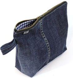 a small denim pouch with zippers on the inside is shown in front of a white background