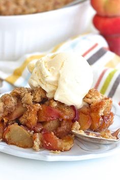 a slice of apple crisp pie on a plate with a scoop of vanilla ice cream