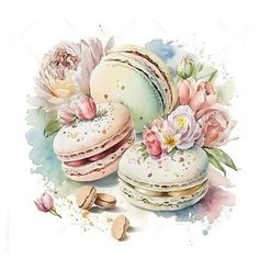 three macaroons with pink flowers and almonds next to each other on a white background