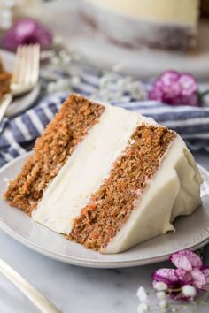 a slice of carrot cake on a white plate