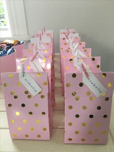 pink and gold polka dot bags with name tags on them