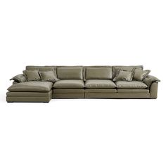 a large sectional couch with pillows on the top and bottom part, in front of a white background