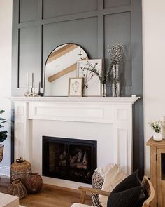 a living room filled with furniture and a fire place under a large mirror on top of a fireplace