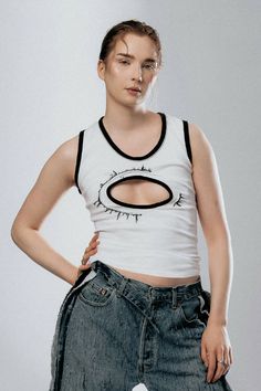 White tank top with black trimming and an embroidery pattern surrounding cut-out chest.COMPOSITION: 100% COTTON Edgy Racerback Tank Top For Spring, Edgy White Tank Top For Spring, Embroidery Pattern, White Tank Top, White Tank, Embroidery Patterns, Cut Out, Composition, Tank Top