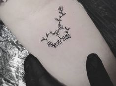 a black and white photo of a flower tattoo