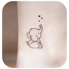 an elephant tattoo on the ankle with hearts coming out of it's back side