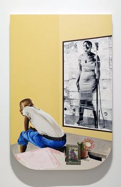 a woman sitting on top of a table in front of a painting