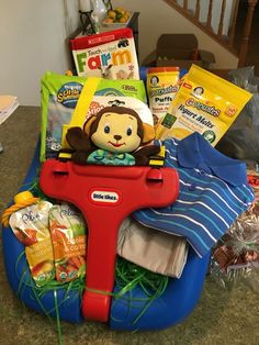 a child's toy car filled with diapers, toys and other items sitting on a table