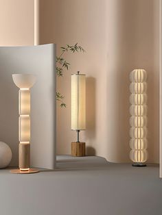 two lamps and a table lamp on a shelf next to each other in a room