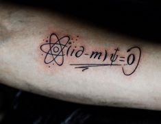 a person with a tattoo on their arm that says, atomic - my - o