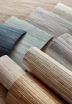 several different colors of wood are laid out on the floor