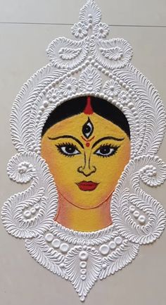 an image of a woman's face in white and yellow with intricate designs on it