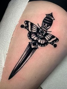 a black and white tattoo with a knife on it