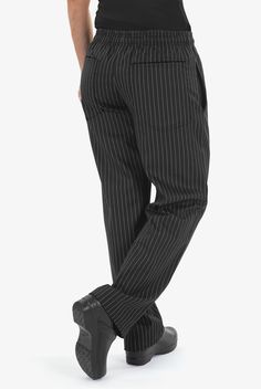 Pants that know how to keep it simple. Our Women's Chef Pants are designed specifically to fit women – not too baggy or too tight. The full-elastic waist has an inner drawstring. 4 pockets hold essential items. And even in a kitchen, pinstripes have a certain polish – which is the idea behind our basic Black Pinstripe print. • Classic fit • Low rise • Elastic waist with inner drawstring • Tapered leg • Total of 4 pockets • 2 side pockets • 2 back patch pockets • Approximate inseam on size M: 31½ Chef Uniforms, Bistro Apron, Chef Pants, Chef Wear, Female Chef, Chef Uniform, Compression Wear, Shop Apron, Denim Design