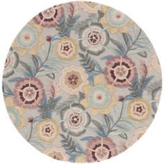 a round rug with flowers and leaves on the inside, in various shades of grey