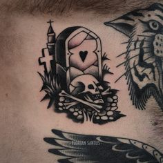 a man with tattoos on his chest has a skull and cross in front of him