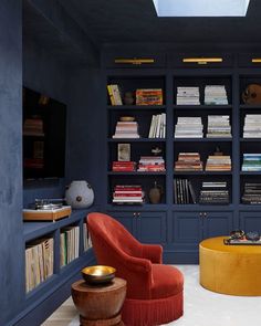 a living room filled with furniture and bookshelves