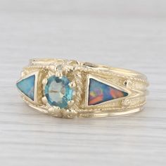 Gemstone Information: - Natural Alexandrite - Carats - 0.40ct Cut - Oval Brilliant Color - Green - Natural Opals - Size - 4 x 6.25 mm Cut - Triangle Color - Blue Green Multicolor Metal: 14k Yellow Gold Weight: 6.4 Grams Stamps: 14k Face Height: 9.3 mm Rise Above Finger: 5.4 mm Band / Shank Width: 3.3 mm This ring is a size 7, but it can be resized up 3 sizes for a $50 fee. Mens Custom Jewelry, Green Rings, Rise Above, Ring Pictures, Modern Ring, La Face, Opal Ring, Multi Stone Ring, Natural Opal