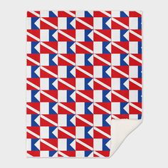 a red, white and blue checkered blanket with an arrow pattern on the back