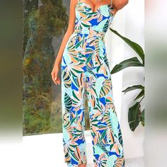 D&M Backless Tropical Print Cami Jumpsuit Size L. Has A Zipper On The Back 100% Polyester Non-Stretch. Sleeveless Printed Blue Jumpsuits And Rompers, Blue Tropical Print Jumpsuits And Rompers For Beach, Blue Floral Print Jumpsuits And Rompers For Party, Party Blue Floral Print Jumpsuits And Rompers, Blue Chic Jumpsuits And Rompers For Beach Season, Chic Blue Jumpsuits And Rompers For Beach Season, Blue Chic Jumpsuits For Beach Season, Spring Blue Tropical Print Jumpsuits And Rompers, Blue Printed Jumpsuits And Rompers For Summer