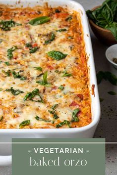 a casserole dish with spinach, cheese and sauce in it on a table