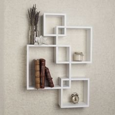 Add a fun and playful flair to your living space with the Danya B. intersecting cube shelves – white. Intersecting cubes create an alluring geometric wall art that doubles as a functional shelf for books, photographs, foliage, and other home décor. The versatile white finish allows easy integration to any color motif. Mount the Danya B. intersecting cube shelves – white in contemporary living rooms or bedrooms to create a fun and modern statement room! Danya B. is a registered trademark of Danya Cube Wall Shelf, White Shelf, Small Shelf, Wooden Wall Shelves, Cube Shelves, Wall Shelves Design, Large Shelves, Floating Wall Shelves, Decorating Shelves