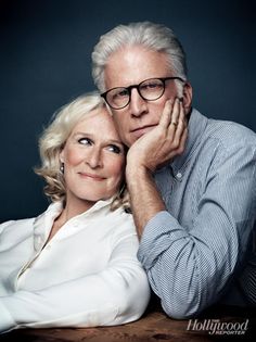 an older man and woman are posing for a photo with their arms around each other