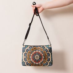 Stylish Mandal Pattern Crossbody Bag Looking for a stylish and functional crossbody bag? Look no further than our versatile crossbody bag, featuring a unique mandal pattern and made of premium faux leather. The bag measures 11″ × 8″ × 1.5″ and is designed with a zip-top closure and multiple inside pockets to keep your essentials secure and organized. But what sets this bag apart is its removable wrist and shoulder straps, allowing you to transform it for day-to-night looks. The dark gray hardwar Faux Leather Clutch Bag For Everyday, Everyday Faux Leather Clutch Bag, Faux Leather Clutch With Adjustable Strap, Faux Leather Clutch Shoulder Bag With Removable Pouch, Pattern Crossbody Bag, Chic Crossbody Bag, Eco Friendly Accessories, Eco Friendly Bags, Eco Chic