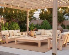 an outdoor living area with patio furniture and string lights