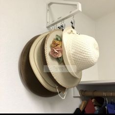 several hats are hanging on the wall