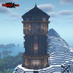 a very tall tower sitting on top of a snow covered hillside