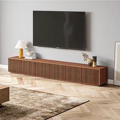 a flat screen tv mounted to the side of a wooden cabinet in a living room