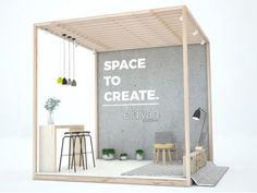 an open space to create with stools and tables in front of the wall that says, space to create