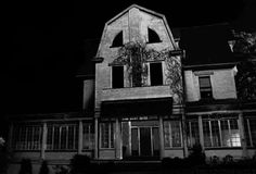 an old house is lit up at night