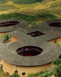 an aerial view of several circular buildings in the countryside