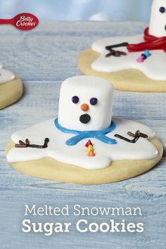 the cookies are decorated like snowmen and have frosting on them