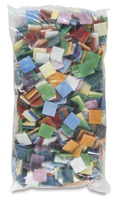 a bag filled with assorted colored glass tiles