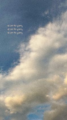 an airplane flying in the sky with some writing on it's side and clouds