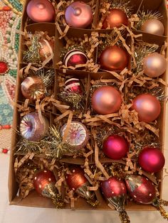 an open box filled with assorted christmas ornaments