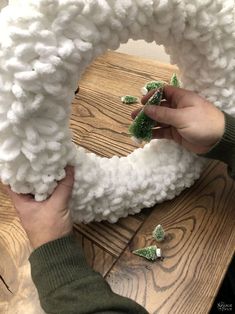 someone is making a wreath out of yarn