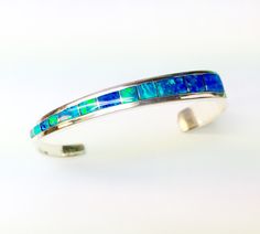 Hand made silver Opal cuff , in blue green Opal from Andamooka, item Made in Australia,these beautiful stones were hand picked for this stunning bangle ,a perfect gift for any occasion Blue Gemstone Cuff Bracelet, Blue Polished Bangle Cuff Bracelet, Elegant Blue Sterling Silver Cuff Bracelet, Unique Blue Bangle Jewelry, Blue Sterling Silver Cuff Bracelet Gift, Green Sterling Silver Bangle As Gift, Fusion Style Sterling Silver Bangle As Gift, Gift Green Sterling Silver Bangle, Elegant Blue Cuff Bracelet With Polished Finish