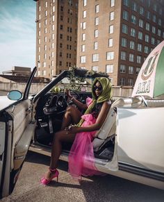 a woman sitting in the driver's seat of a car